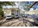 Exterior daytime view of condo building with front parking at 500 Glennes Ln # 202, Dunedin, FL 34698