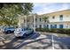 Exterior daytime view of condo building with parking in front at 500 Glennes Ln # 202, Dunedin, FL 34698