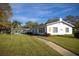 Exterior view of a home with well-manicured lawn and American flag at 500 Glennes Ln # 202, Dunedin, FL 34698