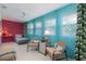 Bright and sunny florida room with colorful decorations, drapes and a ceiling fan at 500 Glennes Ln # 202, Dunedin, FL 34698