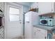Quaint kitchen boasts a vintage refrigerator and white cabinets, adding charm and functionality at 500 Glennes Ln # 202, Dunedin, FL 34698