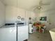 Functional laundry room equipped with washer, dryer, water heater, and utility sink, providing essential amenities at 500 Glennes Ln # 202, Dunedin, FL 34698