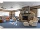 Community library featuring a stone fireplace, cozy seating, and extensive bookshelves in a welcoming and well-lit space at 500 Glennes Ln # 202, Dunedin, FL 34698