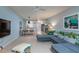 Airy living room featuring blue walls, modern furnishings, and a stylish tropical-themed sofa at 500 Glennes Ln # 202, Dunedin, FL 34698