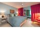 Main bedroom with access to the florida room, side table, and soft colors throughout at 500 Glennes Ln # 202, Dunedin, FL 34698