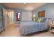 Well lit main bedroom with blue walls, walk-in closet, and a comfortable bed at 500 Glennes Ln # 202, Dunedin, FL 34698