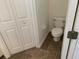 Compact bathroom space featuring a toilet and closet at 513 Summer Sails Dr, Valrico, FL 33594