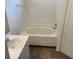 Bathroom featuring an oversized bathtub with white tiled surround at 513 Summer Sails Dr, Valrico, FL 33594