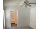 Vaulted ceiling bedroom featuring a ceiling fan and view to ensuite bathroom at 513 Summer Sails Dr, Valrico, FL 33594