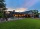 Lush backyard featuring a screened pool and a covered outdoor kitchen and bar area at 5604 Pine Bay Dr, Tampa, FL 33625