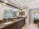 Spacious bathroom with a large vanity with granite countertops, and sinks, and custom tile work at 5604 Pine Bay Dr, Tampa, FL 33625