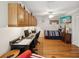 Bedroom and office combination with hardwood floors, a ceiling fan, and a TV at 5604 Pine Bay Dr, Tampa, FL 33625