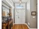 Elegant entryway with hardwood floors, decorative mirror, and stylish overhead lighting fixture at 5604 Pine Bay Dr, Tampa, FL 33625
