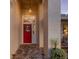 Close-up of the red front door, showing brick walkway, wreath, exterior pillar and hanging light at 5604 Pine Bay Dr, Tampa, FL 33625