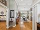 Bright hallway leading to a dining area, showcasing hardwood floors and tasteful decor at 5604 Pine Bay Dr, Tampa, FL 33625