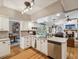 Bright kitchen with white cabinets, stainless steel appliances, and a view of the living room and pool at 5604 Pine Bay Dr, Tampa, FL 33625