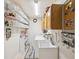 Organized laundry room with storage shelves and cabinets with sink and laundry machines at 5604 Pine Bay Dr, Tampa, FL 33625