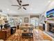 Living room features a fireplace, hardwood floors, comfortable seating, and access to the pool and lanai at 5604 Pine Bay Dr, Tampa, FL 33625