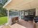 Cozy outdoor kitchen with bar and grill area, seamlessly connecting indoor and outdoor living spaces at 5604 Pine Bay Dr, Tampa, FL 33625