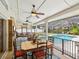 Covered patio featuring a dining table, swing, outdoor seating, and a view of the pool at 5604 Pine Bay Dr, Tampa, FL 33625
