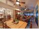 Enclosed patio featuring a dining table, fireplace, TV, and swing with comfortable outdoor seating at 5604 Pine Bay Dr, Tampa, FL 33625
