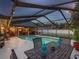 Inviting screened pool with outdoor dining and seating, perfect for evening swims and entertaining at 5604 Pine Bay Dr, Tampa, FL 33625