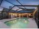 Sparkling pool with screened enclosure, perfect for evening swims and outdoor entertainment at 5604 Pine Bay Dr, Tampa, FL 33625