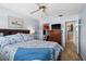 Cozy bedroom with a bed, TV, dresser, walk-in closet, and an en-suite bathroom at 5660 80Th N St # B106, St Petersburg, FL 33709