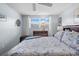Comfortable bedroom featuring a window with blinds, a dresser, and nautical decor at 5660 80Th N St # B106, St Petersburg, FL 33709
