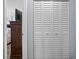 An open door reveals a glimpse into the bedroom, beside a folding closet door at 5660 80Th N St # B106, St Petersburg, FL 33709