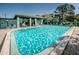 A large community pool is surrounded by lounge chairs, shaded seating areas, and lush landscaping for relaxation and enjoyment at 5660 80Th N St # B106, St Petersburg, FL 33709
