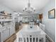 Bright dining room with a chandelier and white wood table, creating an elegant space for gatherings at 5660 80Th N St # B106, St Petersburg, FL 33709