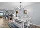 Charming dining room with a chandelier, a white dining set and decorative furnishings at 5660 80Th N St # B106, St Petersburg, FL 33709