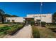 Community entrance to Oleander Lakes Center with well-manicured hedges and lush green grass at 5660 80Th N St # B106, St Petersburg, FL 33709