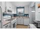 Well-lit kitchen featuring white cabinets, appliances, and a practical layout at 5660 80Th N St # B106, St Petersburg, FL 33709