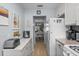 Bright kitchen featuring essential appliances and a pass-through to the dining area at 5660 80Th N St # B106, St Petersburg, FL 33709