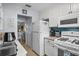Efficient kitchen with white appliances, cabinetry, and a view into the adjacent dining area at 5660 80Th N St # B106, St Petersburg, FL 33709