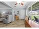 Inviting living area with wood-look flooring, a recliner and a large window offering a pleasant view at 5660 80Th N St # B106, St Petersburg, FL 33709