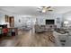 Open-concept living area with wood floors, a ceiling fan, and ample space for relaxation and entertainment at 5660 80Th N St # B106, St Petersburg, FL 33709