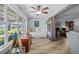 Bright, open living space with wood floors, cozy daybed and artwork, creating a versatile and inviting atmosphere at 5660 80Th N St # B106, St Petersburg, FL 33709
