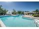 Community pool featuring crystal-clear water, sundeck area and lush landscaping at 5660 80Th N St # B106, St Petersburg, FL 33709