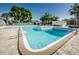 Beautiful community pool featuring crystal-clear water, sundeck area and mature landscaping at 5660 80Th N St # B106, St Petersburg, FL 33709
