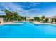 Large community swimming pool with sun loungers at 5660 80Th N St # B106, St Petersburg, FL 33709