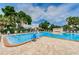 Community swimming pool featuring a wheelchair lift and lounge chairs at 5660 80Th N St # B106, St Petersburg, FL 33709