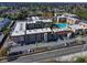 Aerial view of a community with a pool, tennis courts, and ample parking at 5820 N Church Ave # 147, Tampa, FL 33614