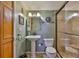 Bathroom with pedestal sink, toilet, and shower with glass door at 5820 N Church Ave # 147, Tampa, FL 33614