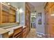 This bathroom features a vanity with a large mirror and warm wood cabinets at 5820 N Church Ave # 147, Tampa, FL 33614