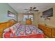 Bedroom features a ceiling fan, wood floors, and a window with natural light at 5820 N Church Ave # 147, Tampa, FL 33614