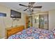 Bedroom features a ceiling fan, wood floors, and bathroom access at 5820 N Church Ave # 147, Tampa, FL 33614