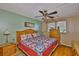 Bedroom features a ceiling fan, wood floors, and a window with natural light at 5820 N Church Ave # 147, Tampa, FL 33614